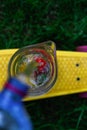 Defocus bubbles and jet of water pouring from plastic bottle in glass jug of lemonade with strawberry, slice lemon and