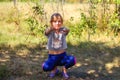 Defocus caucasian preteen girl doing physical exercise in park, forest, outdoor, outside. Healthy wellness lifestyle. Squats with Royalty Free Stock Photo