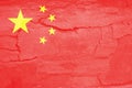 Defocus China flag, official colors and proportion correctly. National China flag. Stone wall background. Crack