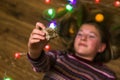 Defocus Christmas girl holding gift on the floor. Top above high angle view photo of happy young woman hold hands face Royalty Free Stock Photo