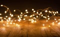 Defocus christmas lights on wooden background. selective focus on wood planks Royalty Free Stock Photo