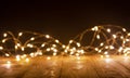 Defocus christmas lights on wooden background. selective focus on wood planks Royalty Free Stock Photo