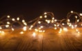 Defocus christmas lights on wooden background. selective focus on wood planks Royalty Free Stock Photo