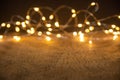 Defocus christmas lights on wooden background. selective focus on wood planks Royalty Free Stock Photo