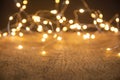 Defocus christmas lights on wooden background. selective focus on wood planks Royalty Free Stock Photo