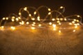 Defocus christmas lights on wooden background. selective focus on wood planks Royalty Free Stock Photo