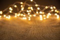 Defocus christmas lights on wooden background. selective focus on wood planks Royalty Free Stock Photo