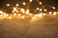 Defocus christmas lights on wooden background. selective focus on wood planks Royalty Free Stock Photo