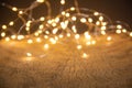 Defocus christmas lights on wooden background. selective focus on wood planks Royalty Free Stock Photo