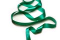 Defocus close-up Christmas tree made of green ribbon on white ba