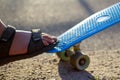 Defocus close-up little boy doing tricks on a penny skateboard. Young kid riding in the park on a skateboard. Child