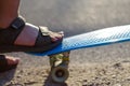 Defocus close-up little boy leg on a penny skateboard. Young kid riding in the park on a skateboard. Child learns to