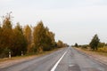 Defocus empty road among the autumn forest, perspective, selective focus. Beautiful landscape. Empty asphalt road in Royalty Free Stock Photo