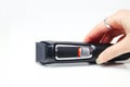 Defocus female hand holding electric clipper on white background. Professional hair clipper on white background