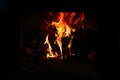 Defocus fire flame background. Firewood burning in old stove or oven. Dark and black. Orange flame. Heat energy. Out of