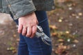 Defocus gardening scissors. Female hand holding gardening scissors. Gardener with pruning shears in hand. Nature blur