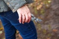 Defocus gardening scissors. Female hand holding gardening scissors. Gardener with pruning shears in hand. Nature blur