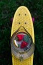 Defocus glass jug of lemonade with strawberry, slice lemon and leaves of mint on yellow penny board, skateboard. Blurred Royalty Free Stock Photo