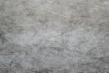 Defocus grey spunbond non-woven geotextile close-up macro. Small spots. Dirtied texture. Design, background, backdrop. Out of