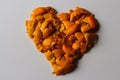 Defocus heart of dried orange and tangerine skins. On a gray background. Lots of small pieces of dried orange peel laid Royalty Free Stock Photo