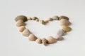 Defocus heart made of sea shells lying on a beach white summer background. Suggesting sea concept. Overhead view Royalty Free Stock Photo