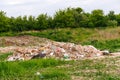 Defocus huge ruins , wreck in Ukraine, war. Concept of ecology. Large garbage pile on nature green grass background