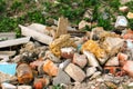 Defocus huge ruins, wreck in Ukraine, war. House after russian attack. Large garbage pile on nature green grass Royalty Free Stock Photo