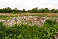 Defocus huge ruins, wreck in Ukraine, war. House after russian attack. Large garbage pile on nature green grass Royalty Free Stock Photo