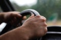 Defocus male hand holding steering wheel. A man& x27;s hand handle steering wheel car for driving. Traffic jam, driving Royalty Free Stock Photo