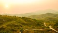 Defocus of mountain landscape and valley road with orange sky at sunset, Thailand. Background of hill landscape. Nature and Royalty Free Stock Photo