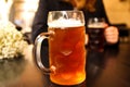 Defocus mug of light beer. Closeup of two hands clinking beer stein glasses. Two friends drinking beer in pub. Dating Royalty Free Stock Photo