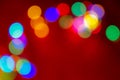 Defocus multicolored lights. Red bokeh background. Abstract christmas texture