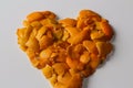 Defocus orange heart shaped Christmas background from the peels of orange and mandarin on a white background. Many small Royalty Free Stock Photo