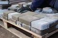 Defocus paver master. Man lays paving stones in layers. Garden brick pathway paving by professional worker. Hands of Royalty Free Stock Photo