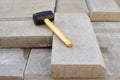 Defocus paving hammer. Stack of paving stones. Garden brick pathway paving by professional paver worker. Laying gray