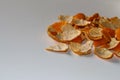 Defocus peels of orange and tangerine on a white background. Many small pieces of dried peel of mandarin. Orange bright Royalty Free Stock Photo