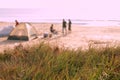 Defocus photo with view on the grass and background of camping and people at the beach
