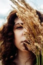 Defocus portrait of beautiful young curly red-haired girl with ears