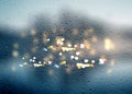 Defocus rain drops on  window glass and car night traffic light blurred flares template backhround rainy season copy space Royalty Free Stock Photo