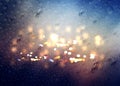 Defocus rain drops on  window glass and car night traffic light blurred flares template backhround rainy season copy space Royalty Free Stock Photo