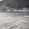 Defocus seashore summer landscape monochrome water pebble nature hill Bay.