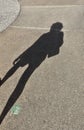 Defocus shadow silhouette of woman on gray textured asphalt surface