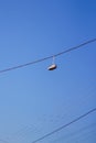 Defocus sneakers hanging from electrical wire against a blue sky background. The concept of urban culture, sale of Royalty Free Stock Photo