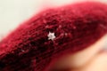 Defocus snowflake on a dark red background. Beautiful Macro snowflake, everyone is different. Closeup winter symbol. Out Royalty Free Stock Photo