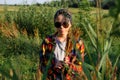 Defocus teen or preteen girl walking on nature background. Little kid girl making bunch of pampas grass. Blurred reed on Royalty Free Stock Photo