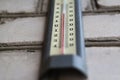 Defocus thermometer. Heat, thermometer shows the temperature is hot in the grey wall, Summer. Hot summer or heat wave