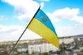 Defocus Ukraine flag. Large national symbol fluttering in blue sky. Small yellow blue Ukrainian state flag, Independence