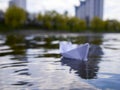 Defocus white paper boat in blue water. Royalty Free Stock Photo