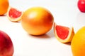 Defocus whole and piece of a red grapefruit on white background. Healthy food concept. Fresh orange juice. Vegan Royalty Free Stock Photo