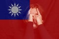 Defocus woman on Taiwan flag. Concept of border conflict, independence and freedom shipment or free trade agreement